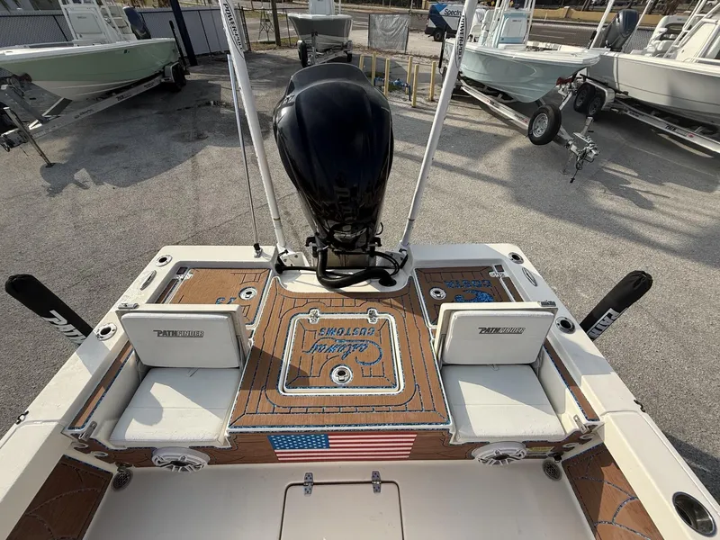 Slide: The Image of 2021 Pathfinder 2400 TRS boat with motor, American flag detail, and seating. - 34