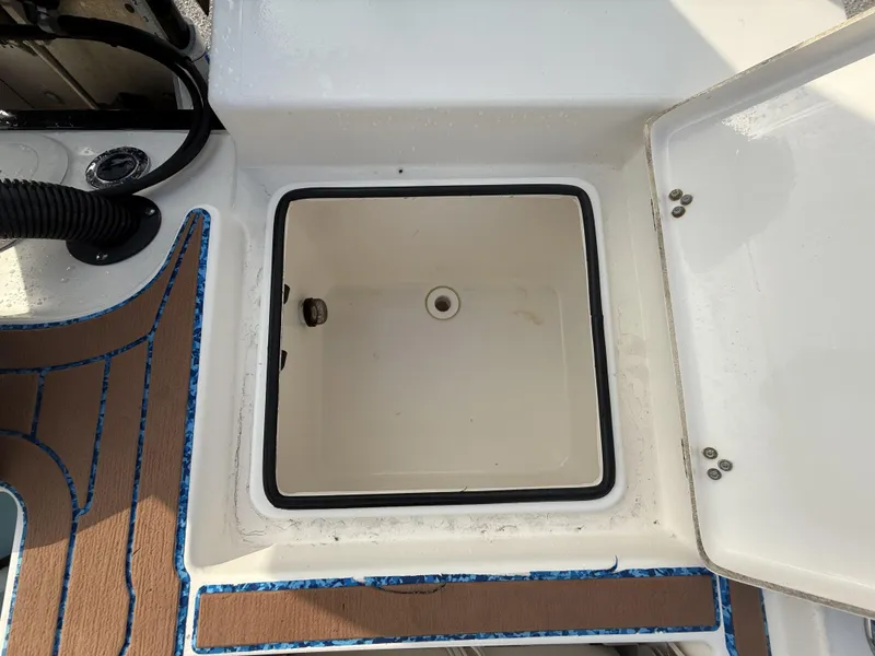 Slide: The Image of Open storage compartment on a 2021 Pathfinder 2400 TRS boat. - 35