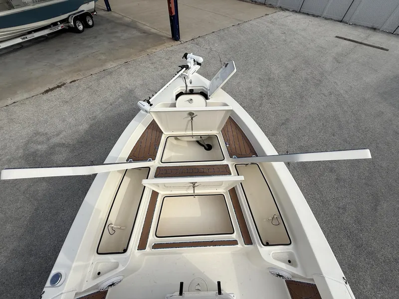 Slide: The Image of 2021 Pathfinder 2400 TRS boat deck with open storage compartments and trolling motor. - 36
