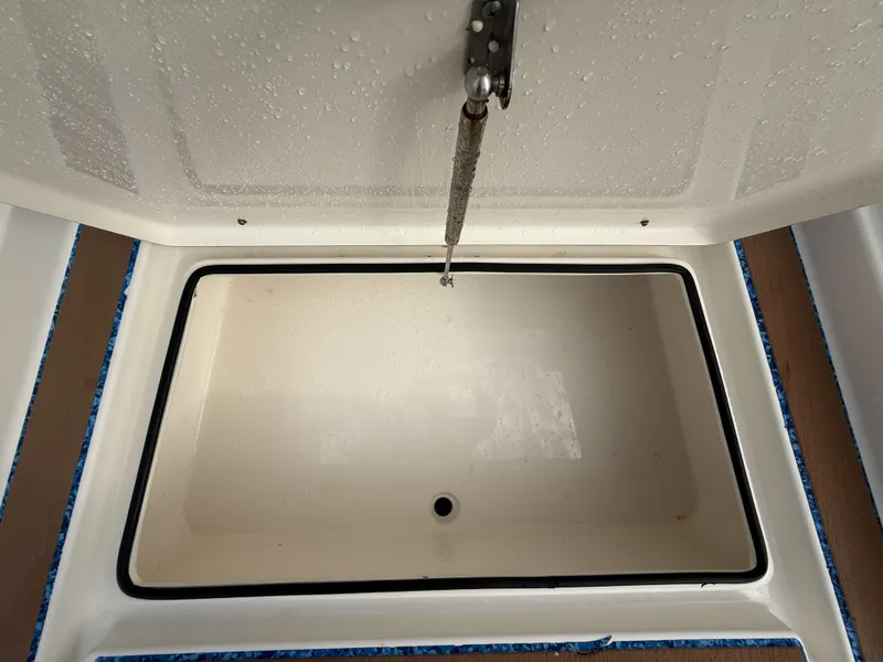 Slide: The Image of Open storage compartment on 2021 Pathfinder 2400 TRS boat, showing interior details. - 37