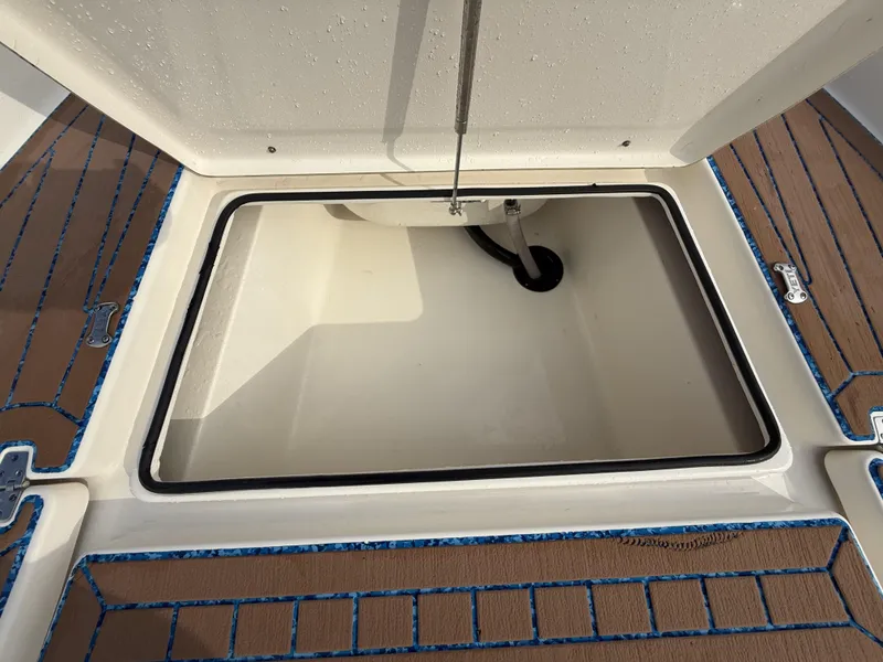 Slide: The Image of Open storage compartment on a 2021 Pathfinder 2400 TRS boat deck. - 38