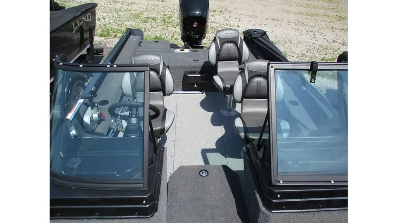 Slide: The Image of 2025 Lund Adventure 1775 Sport boat interior with seating and steering wheel. - 12