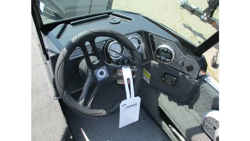 Slide: The Image of 2025 Lund Adventure 1775 Sport boat dashboard with steering wheel and gauges. - 14