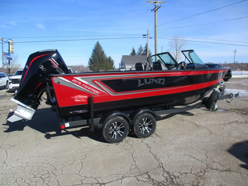 Slide: The Image of 2025 Lund 2075 Fisherman boat on trailer, black and red design, parked outdoors. - 1