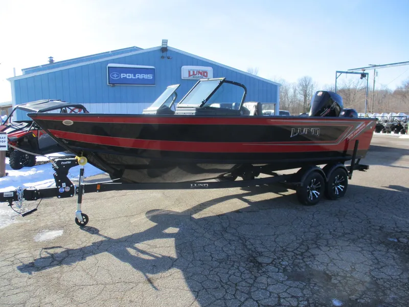 Slide: The Image of 2025 Lund 2075 Fisherman boat on trailer, parked outside dealership. - 2