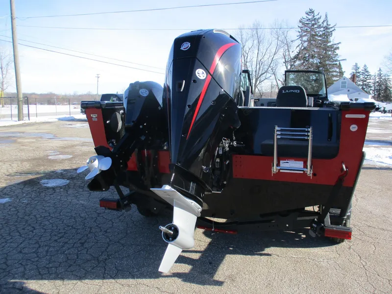 Slide: The Image of 2025 Lund 2075 Fisherman boat with dual outboard motors, parked on a snowy day. - 3