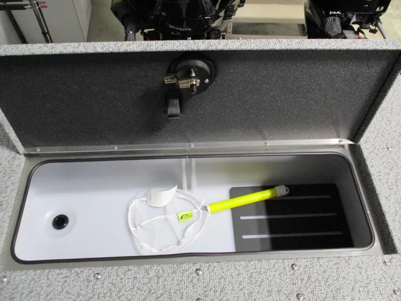 Slide: The Image of 2025 Lund 2075 Fisherman boat storage compartment with net and yellow handle. - 5