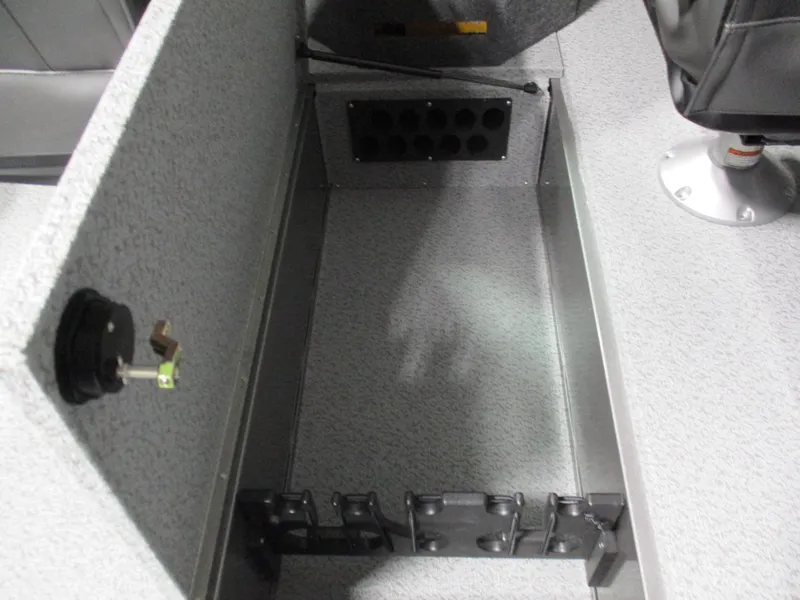 Slide: The Image of 2025 Lund 2075 Fisherman boat interior storage compartment with rod holders and seat base. - 6