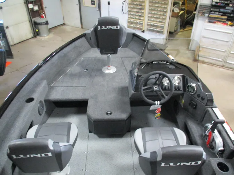 Slide: The Image of 2025 Lund 1775 Adventure SS boat interior with steering console and seating. - 4