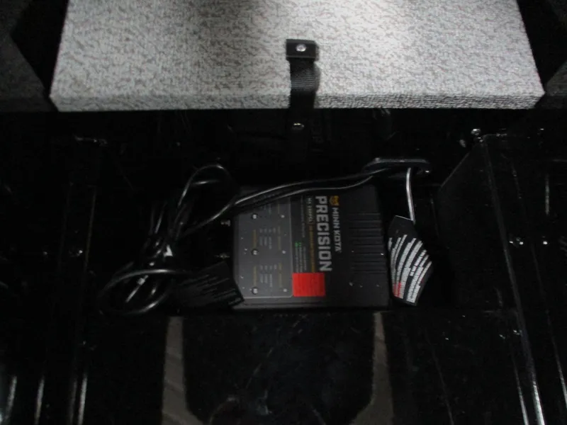 Slide: The Image of Battery charger inside 2025 Lund 1775 Adventure SS boat compartment. - 8