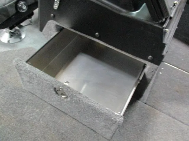 Slide: The Image of Open storage compartment in 2025 Lund 1975 Pro V Sport boat interior. - 10