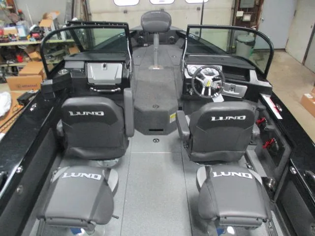 Slide: The Image of Interior of 2025 Lund 1975 Pro V Sport boat with four seats and steering console. - 15