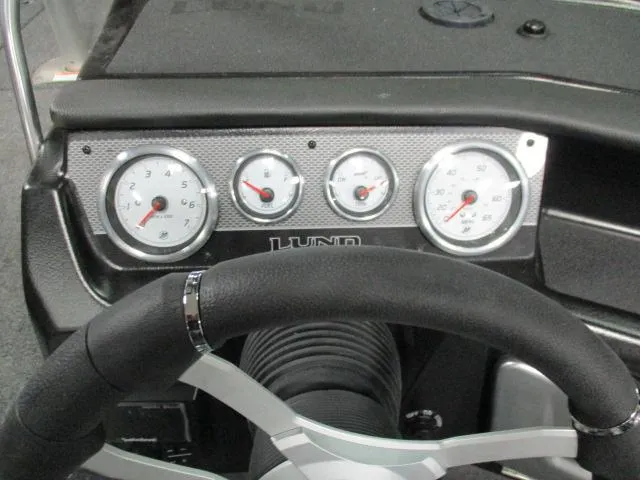 Slide: The Image of Interior of 2025 Lund 1975 Pro V Sport boat, featuring steering wheel and seating. - 17