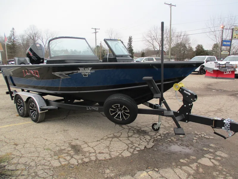 Slide: The Image of 2025 Lund 1975 Pro V Sport boat on trailer, parked outdoors. - 26