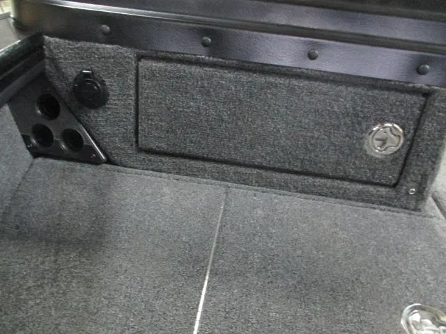 Slide: The Image of Interior of 2025 Lund 1975 Pro V Sport boat, featuring carpeted storage compartment. - 7