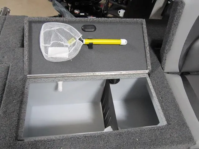 Slide: The Image of Storage compartment in 2025 Lund 1875 Crossover XS boat with a yellow-handled net. - 11