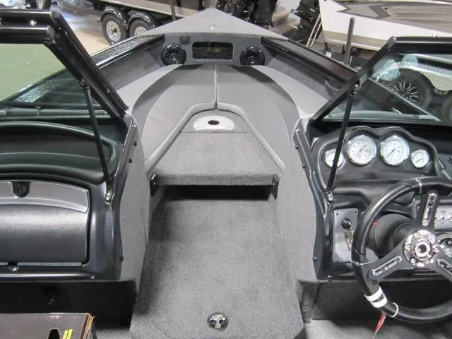 Slide: The Image of 2025 Lund 1875 Crossover XS boat interior with steering wheel and dashboard controls. - 12