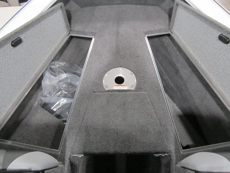 Slide: The Image of 2025 Lund 1875 Crossover XS boat interior with open storage compartments. - 5
