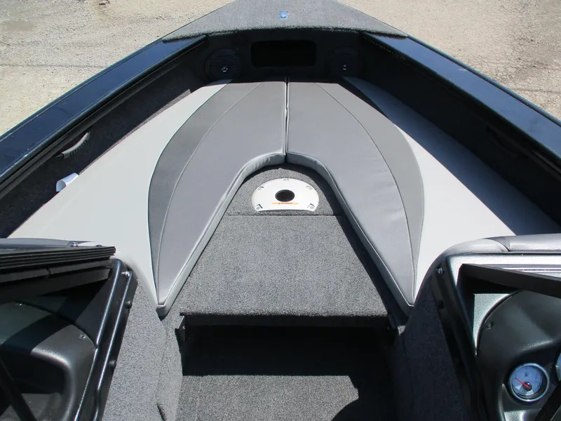 Slide: The Image of 2025 Lund 1875 Crossover XS boat interior with cushioned seating and storage compartments. - 8