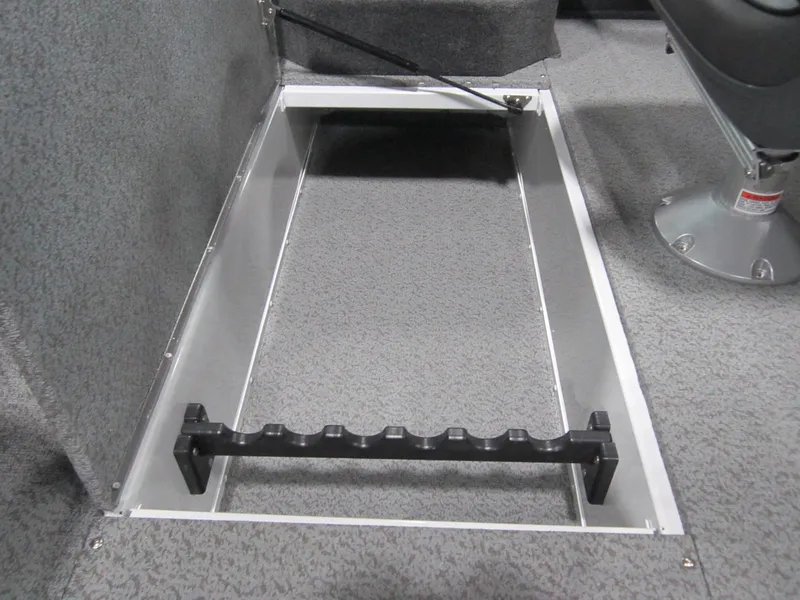 Slide: The Image of 2025 Lund 1875 Crossover XS boat interior storage compartment with rod holder. - 9