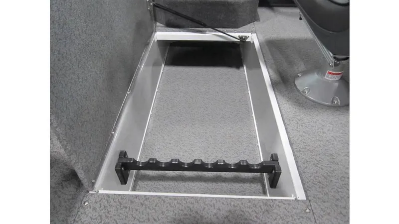 Slide: The Image of 2025 Lund Crossover XS 1875 boat interior storage compartment with rod holder. - 12