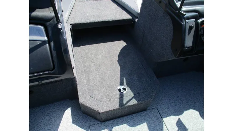 Slide: The Image of Interior of 2025 Lund Crossover XS 1875 boat, featuring carpeted flooring and seating area. - 14