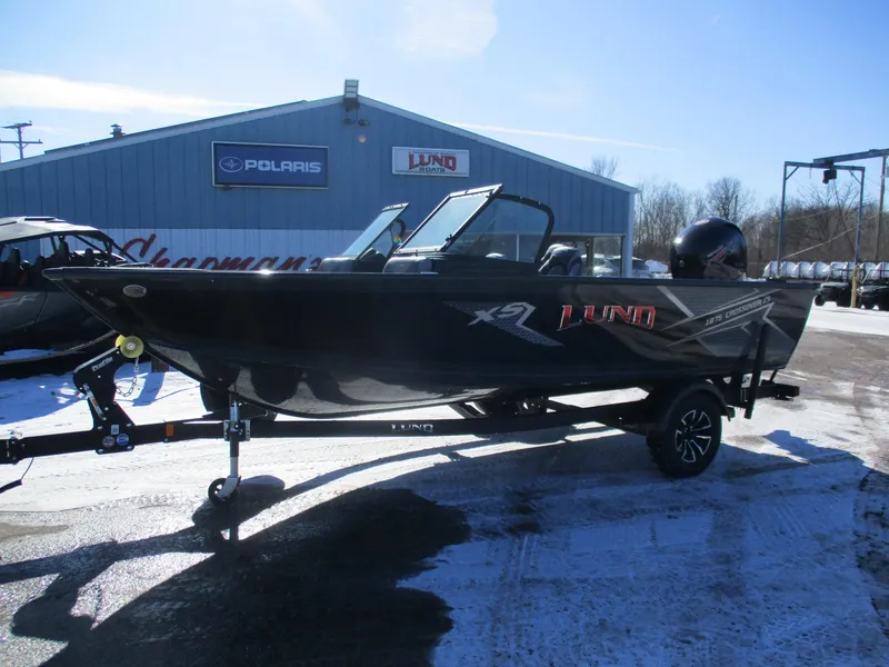 Slide: The Image of 2025 Lund Crossover XS 1875 boat on trailer in snowy dealership lot. - 3