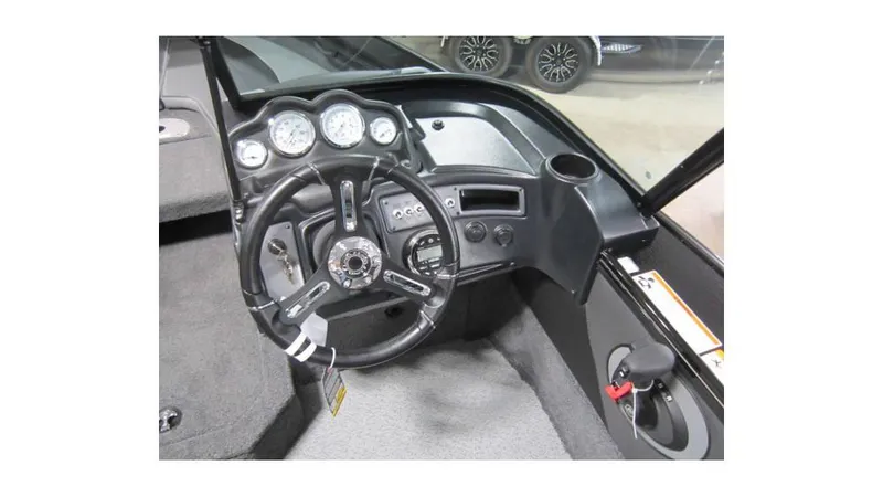 Slide: The Image of 2025 Lund Crossover XS 1875 boat dashboard with steering wheel and gauges. - 5