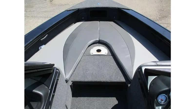 Slide: The Image of 2025 Lund Crossover XS 1875 boat interior with gray seating and carpeted flooring. - 6