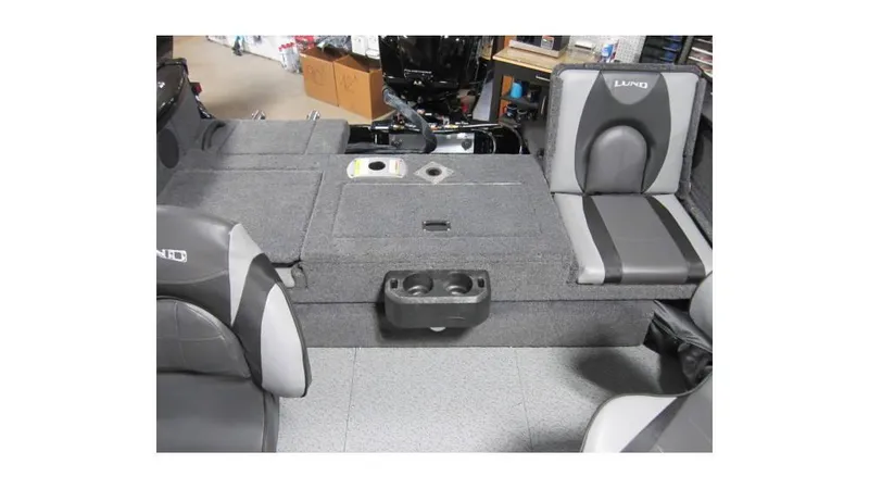 Slide: The Image of 2025 Lund Crossover XS 1875 boat interior with gray seating and storage compartments. - 7