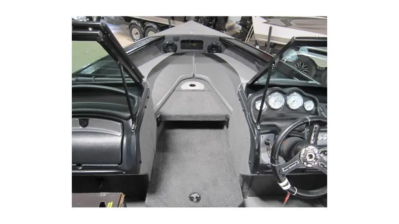 Slide: The Image of 2025 Lund Crossover XS 1875 boat interior with steering wheel and dashboard gauges. - 9