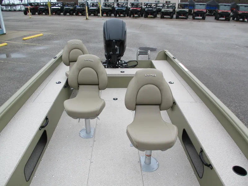 Slide: The Image of 2025 Lund Alaskan 1875 Tiller boat interior with beige seats and motor. - 10
