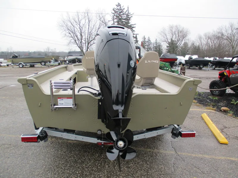 Slide: The Image of 2025 Lund Alaskan 1875 Tiller boat with outboard motor, parked on a trailer. - 8