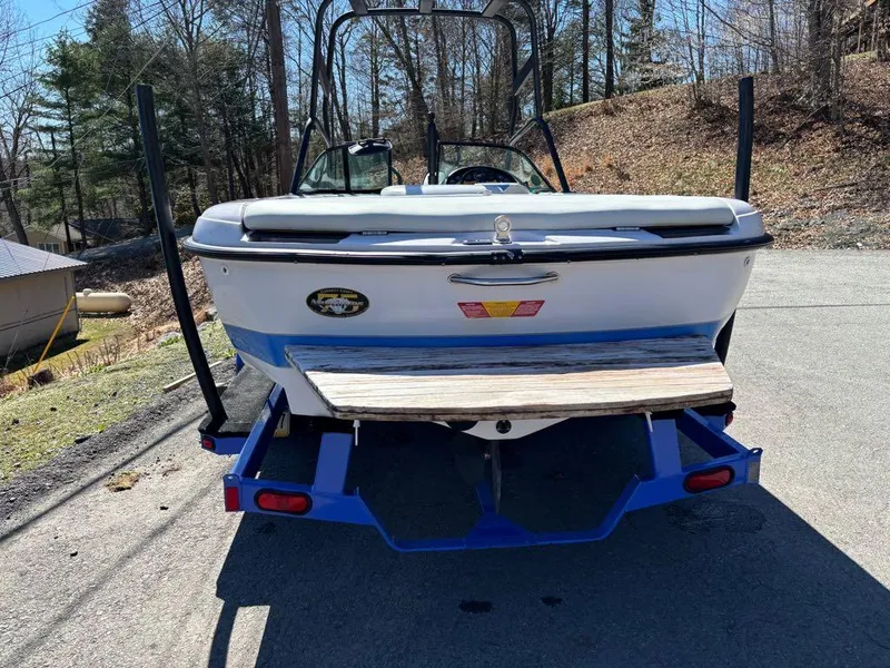 Slide: The Image of 2000 Nautique Air Nautique boat on trailer, parked outdoors, rear view. - 12