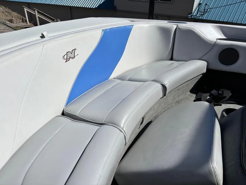 Slide: The Image of 2000 Nautique Air Nautique boat interior with gray and blue seating. - 17