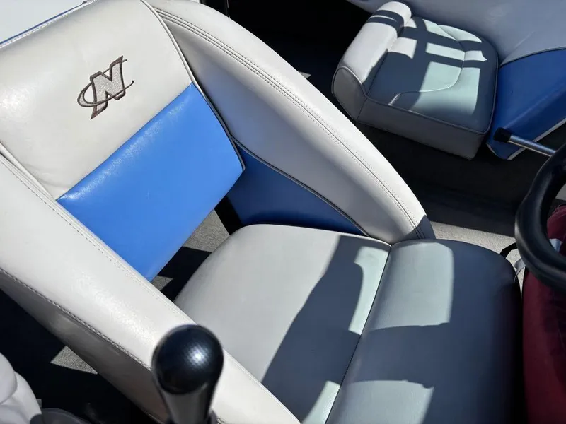 Slide: The Image of 2000 Nautique Air Nautique boat interior with blue and white seating. - 18