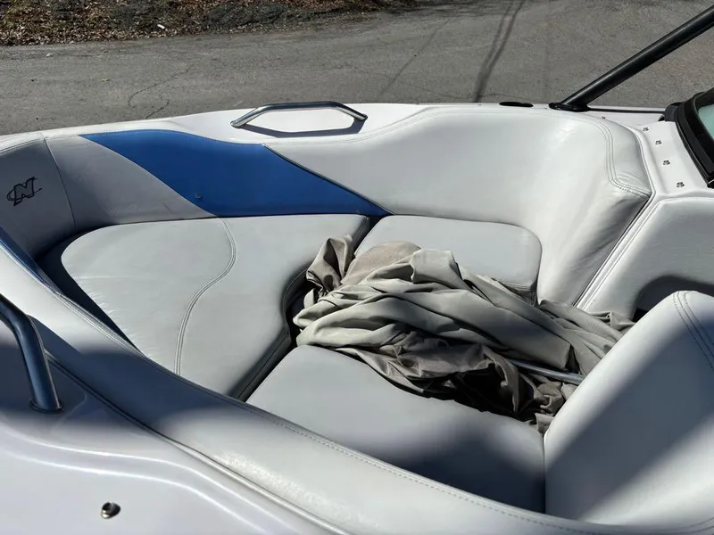 Slide: The Image of 2000 Nautique Air Nautique boat interior with white and blue seating. - 8