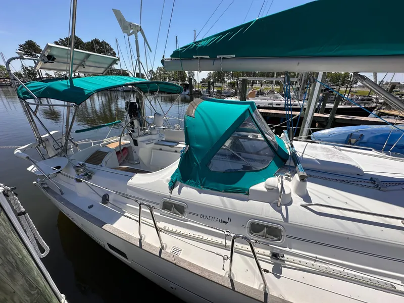 The Image of Beneteau 411 sailboat, 2000 model, docked with green canopy and clear skies. - 1
