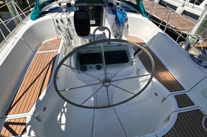Slide: The Image of Cockpit of 2000 Beneteau 411 sailboat with wooden deck and steering wheel. - 13