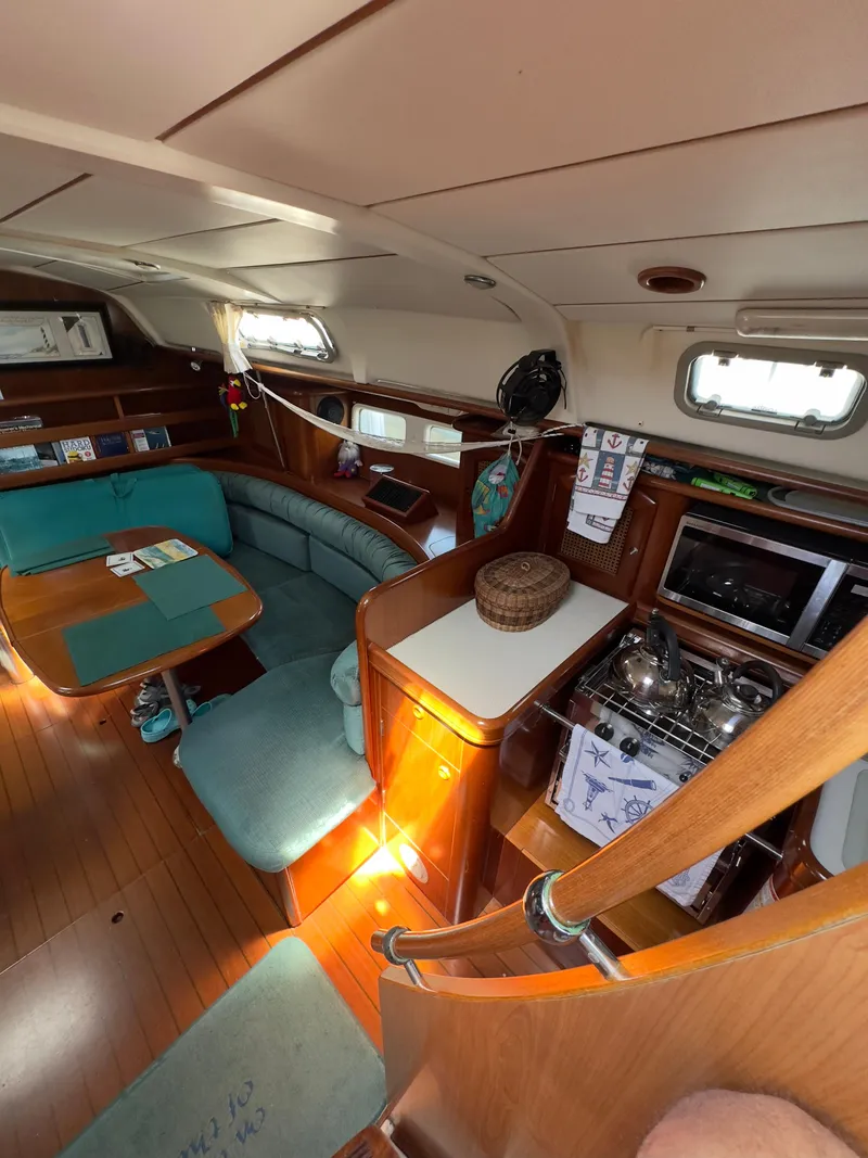 Slide: The Image of Interior of a 2000 Beneteau 411 sailboat with dining area and kitchen. - 17