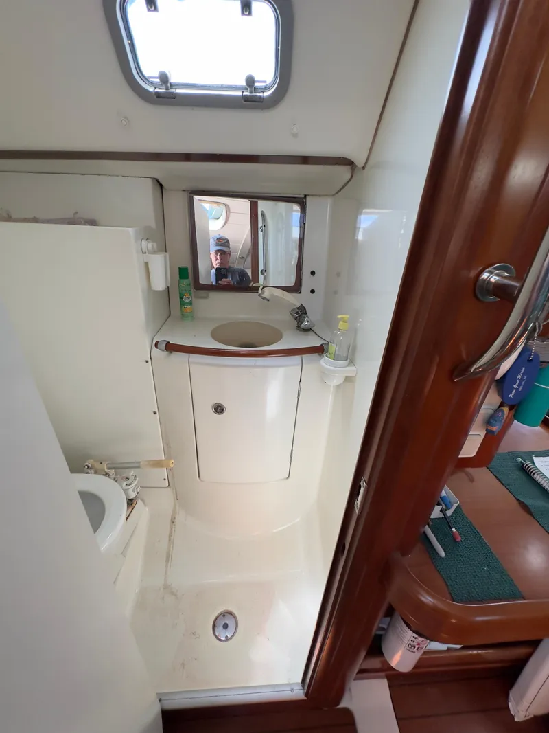Slide: The Image of Beneteau 411 2000 yacht bathroom with sink, mirror, and toilet. - 35