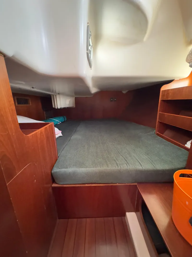 Slide: The Image of Cozy cabin interior of 2000 Beneteau 411 sailboat with wooden finish and comfortable bedding. - 36