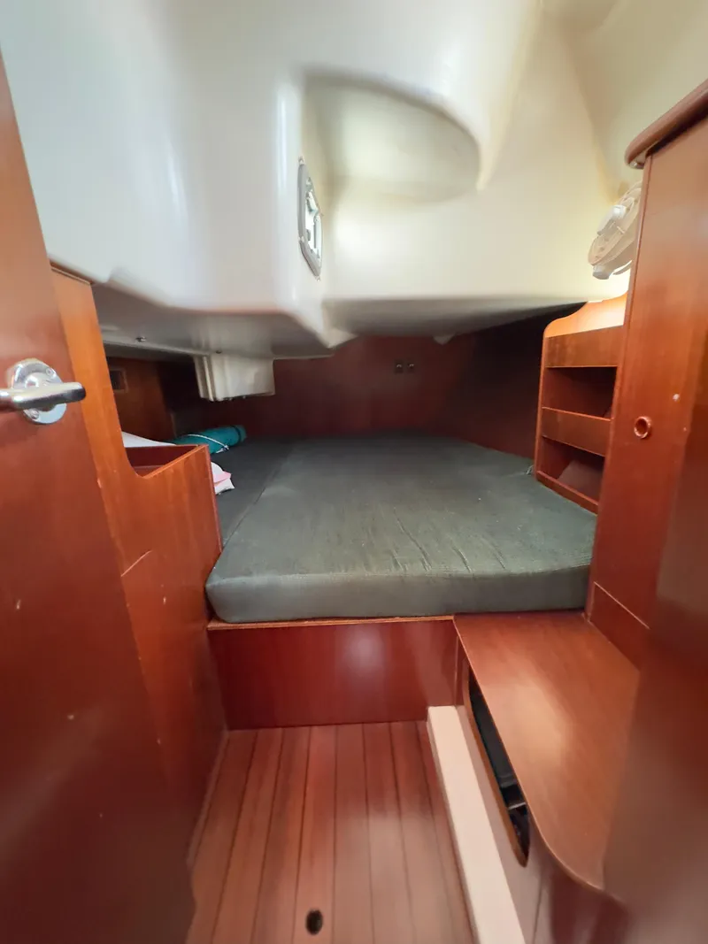 Slide: The Image of Cozy cabin interior of a 2000 Beneteau 411 sailboat with wooden furnishings. - 37