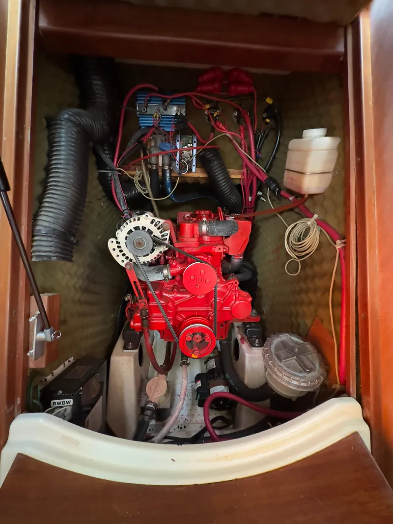 Slide: The Image of Engine compartment of a 2000 Beneteau 411 sailboat, showcasing wiring and components. - 38