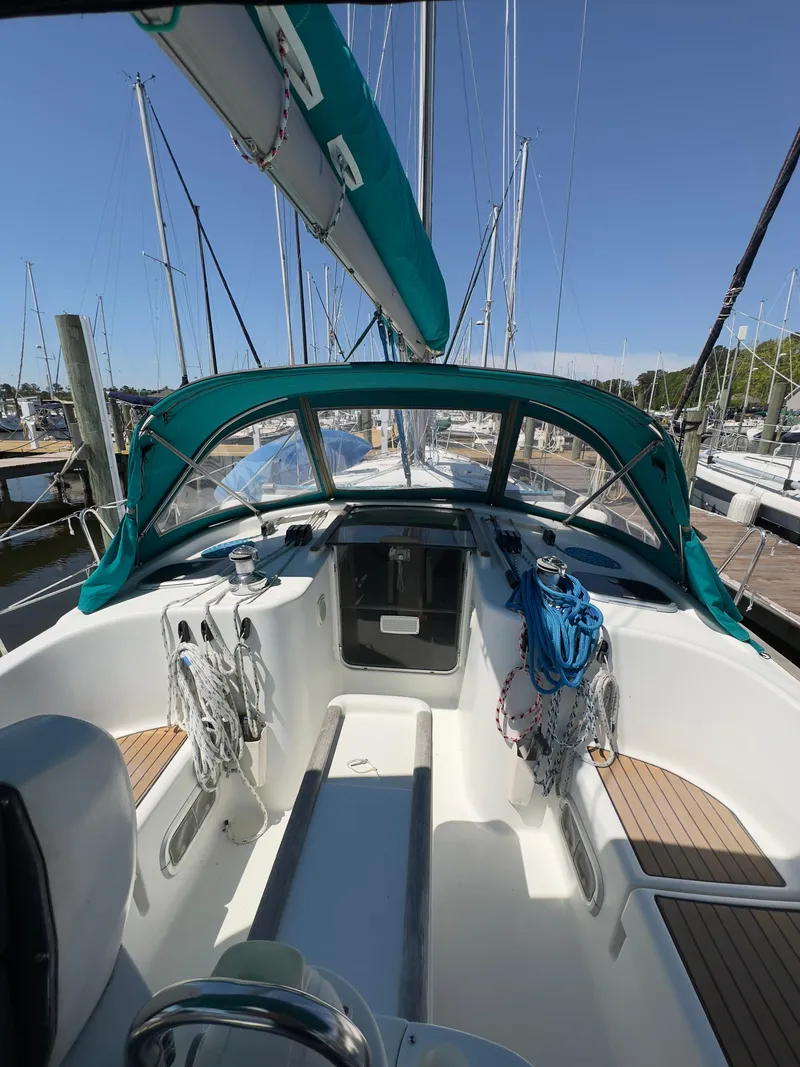 Slide: The Image of 2000 Beneteau 411 sailboat cockpit with teal canopy and mooring lines. - 4