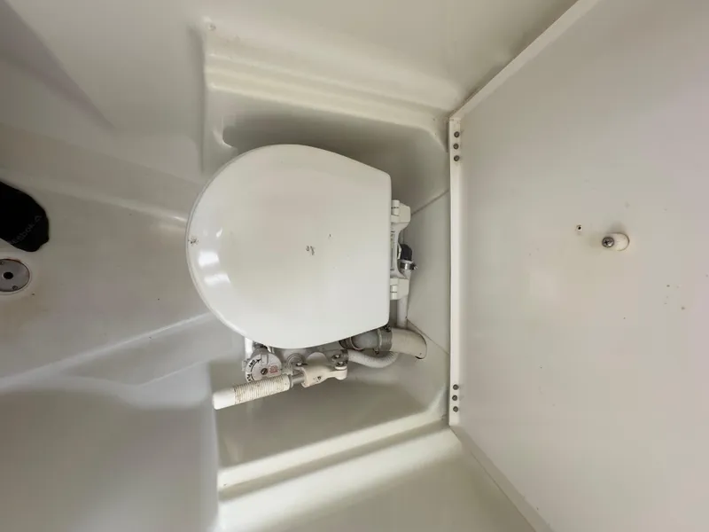Slide: The Image of Toilet in a 2000 Beneteau 411 sailboat, featuring compact marine design. - 48