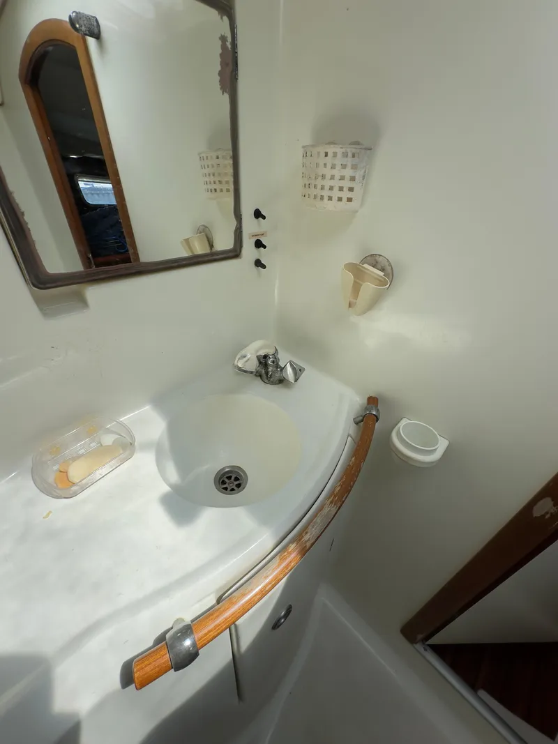 Slide: The Image of Beneteau 411 yacht bathroom with sink, mirror, and wooden handrail, 2000 model. - 49