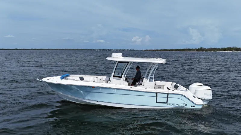 The Image of 2019 Robalo R302 Center Console boat on open water, side view. - 0