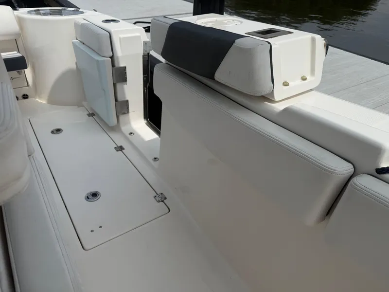 Slide: The Image of 2019 Robalo R302 Center Console boat interior with seating and storage compartments. - 14