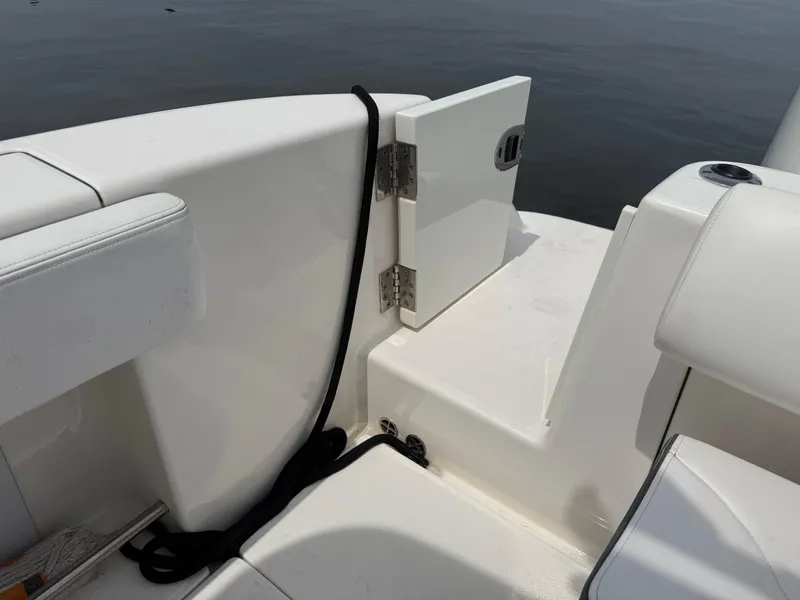 Slide: The Image of 2019 Robalo R302 Center Console boat interior with open hatch and seating. - 17